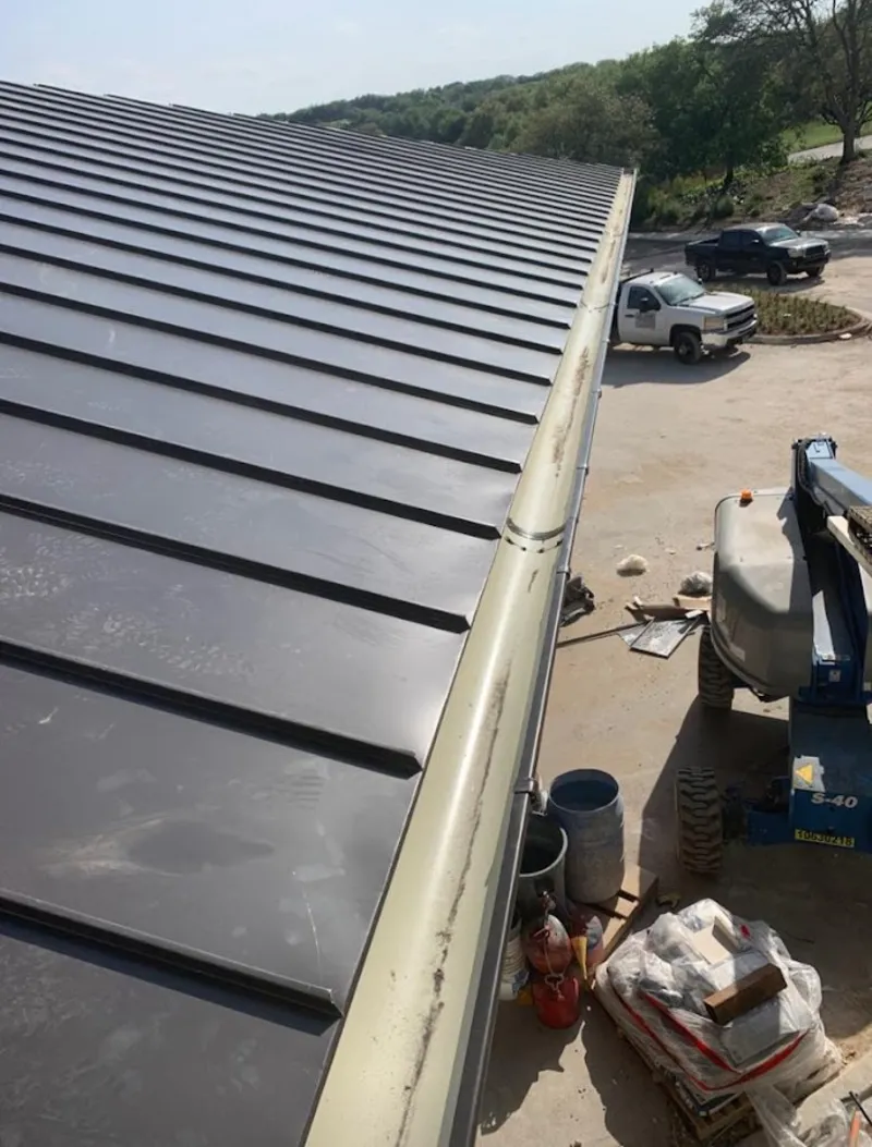 Standing seam panel and gutter detail on a metal roofing jobsite in Duncan